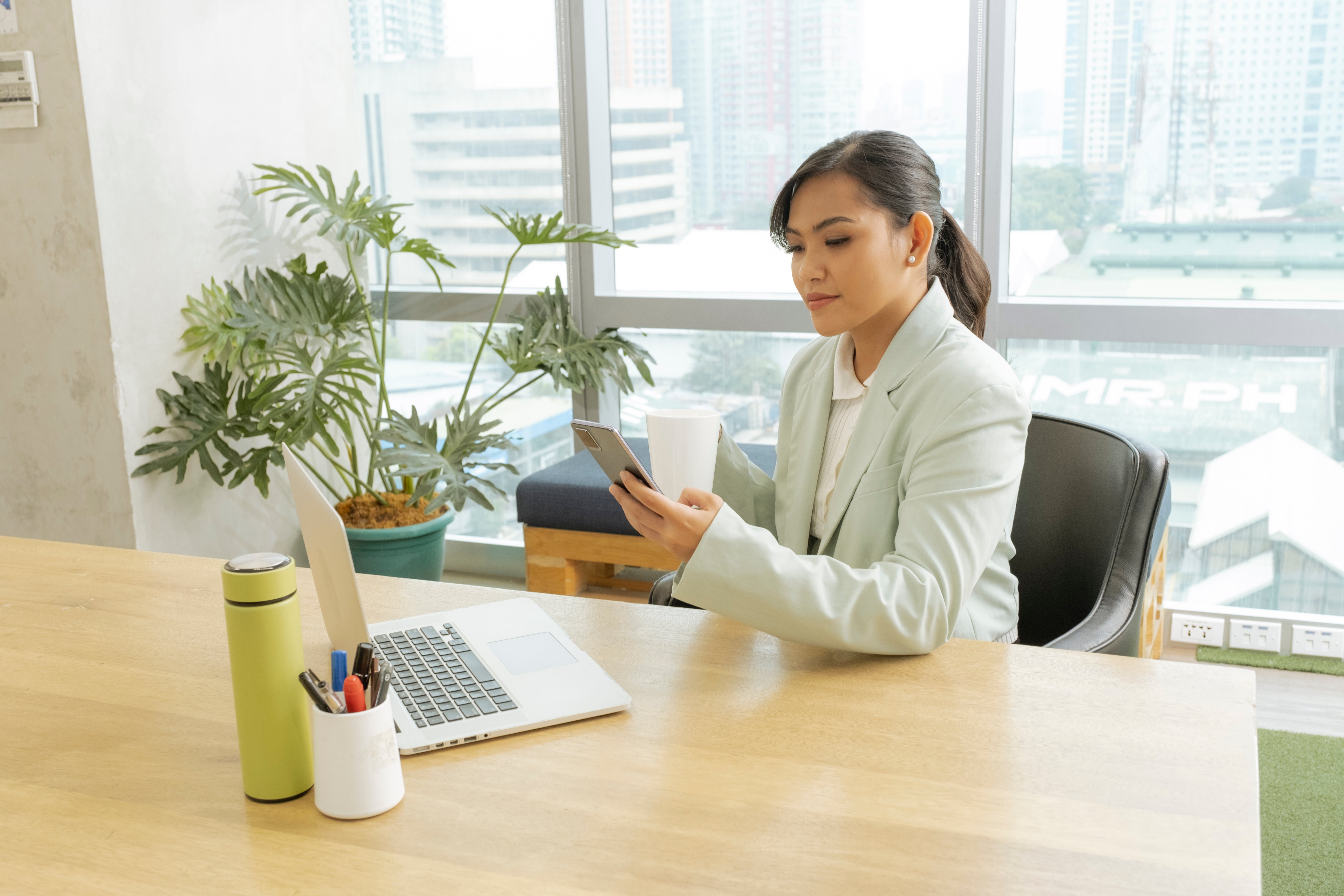 lady using phone in her office table